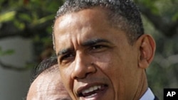 U.S. President Barack Obama (R) introduces Dartmouth College President Jim Yong Kim as his nominee to be the next president of the World Bank, in the Rose Garden of the White House in Washington, March 23, 2012. 