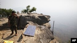 A Cambodian soldier talks on a phone from his position at the Preah Vihear temple on the border between Thailand and Cambodia, February 9, 2011. The UN's highest court has ordered both Cambodia and Thailand to immediately withdraw all troops from a newly 