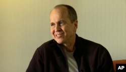 FILE - In this image made from video, Australian journalist Peter Greste speaks during an interview a day after his release from prison in Egypt, in Larnaca, Cyprus, Monday, Feb. 2, 2015. Greste said Monday that his freedom was something of a "rebirth" and that