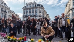 People light candles at a memorial set up outside the stock exchange in Brussels on March 22, 2016. 