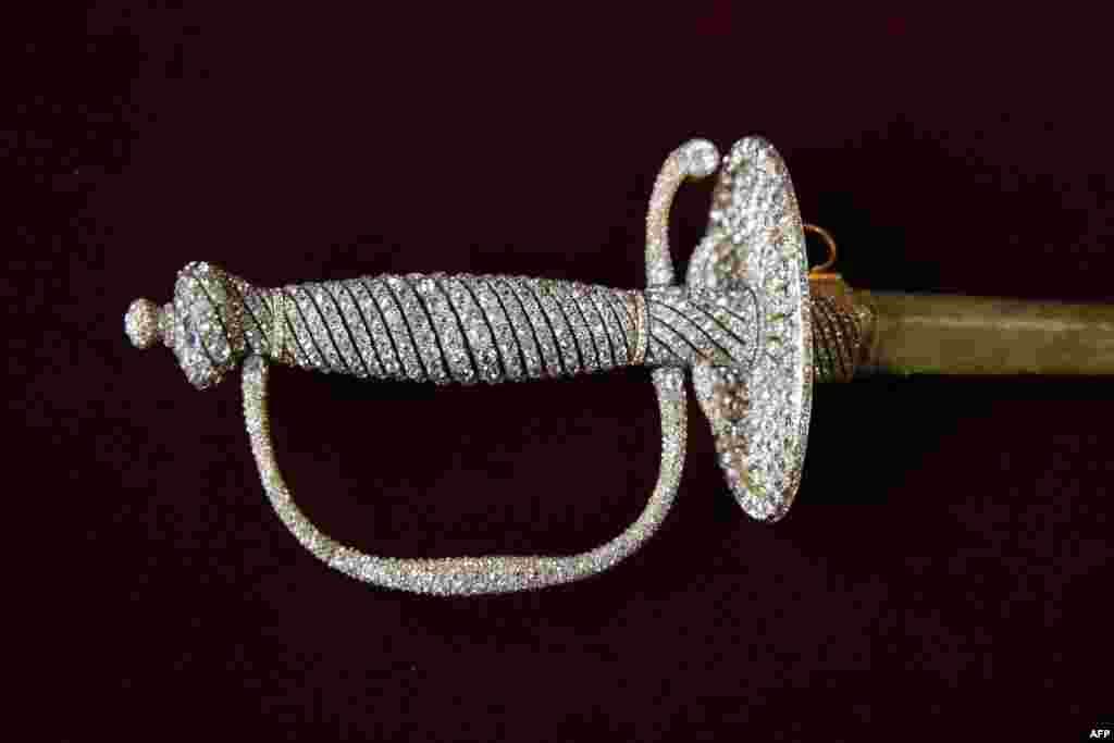 A diamond-encrusted sword, from the royal family of Monaco's private Napoleonic collection, is shown at Paris’ Osenat auction house. Nearly 1,000 objects will be offered Nov. 15-16. 