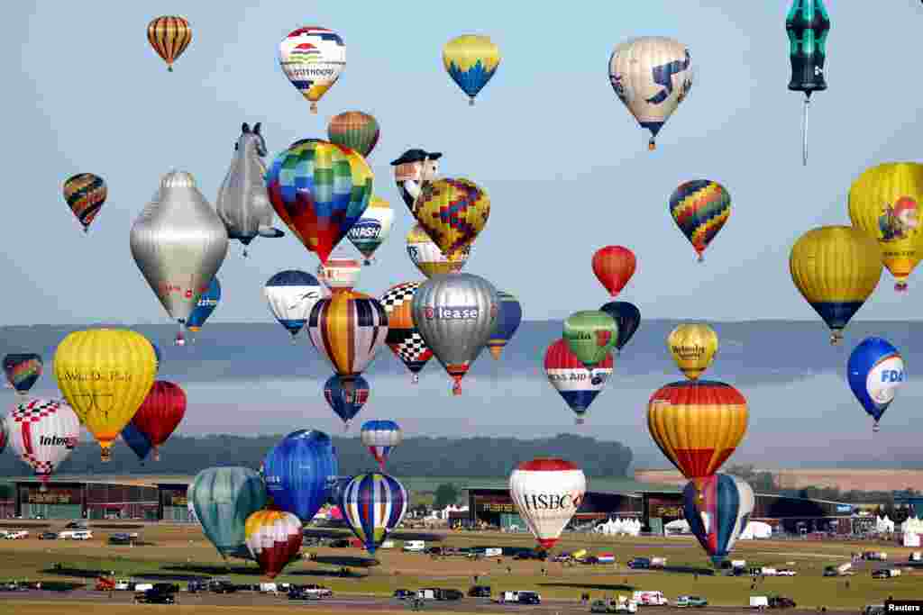Hundreds of hot air balloons take part in the Great Line at the Mondial Air Ballons festival, in an attempt to break the 2017 record of 456 balloons lining up in an hour during the biggest meeting in the world, in Chambley, France.