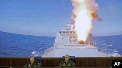 FILE - Colonel General Sergei Surovikin, commander of the Russian forces in Syria (left) and Col. Gen. Sergei Rudskoi of the Russian General Staff, attend a briefing in the Russian Defense Ministry in Moscow, Russia, June 9, 2017.