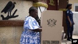 FILE - A woman fills in her ballots in presidential and parliamentary elections at a polling station in Accra, Ghana, Dec. 7, 2012. The electoral commission of Ghana has dismissed local media reports that the electoral body is not fully prepared to organize the anticipated November 7 presidential, parliamentary and local elections. 