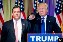 Republican presidential candidate Donald Trump, accompanied by New Jersey Gov. Chris Christie, left, takes questions from members of the media during a news conference on Super Tuesday