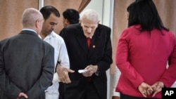 FILE - Former military commnader Jose Ramon Fernandez, center, casts his ballot to choose a new leadership for the National Assembly in Havana, Cuba, April 18, 2018.