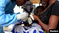 File - A South Sudanese baby suffering from cholera is attended to by medics at the Juba Teaching Hospital in Juba. 
