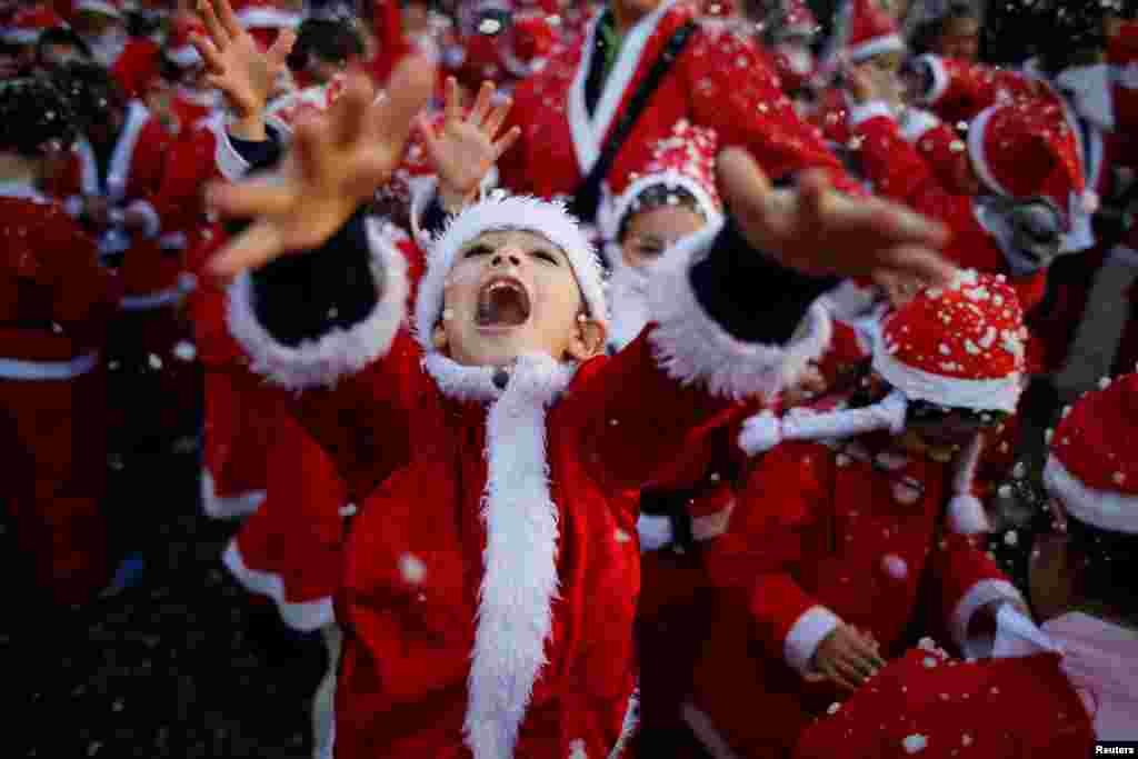 Children dressed as Santa Claus participate in a parade held to collect food for the needy, in Lisbon, Portugal.