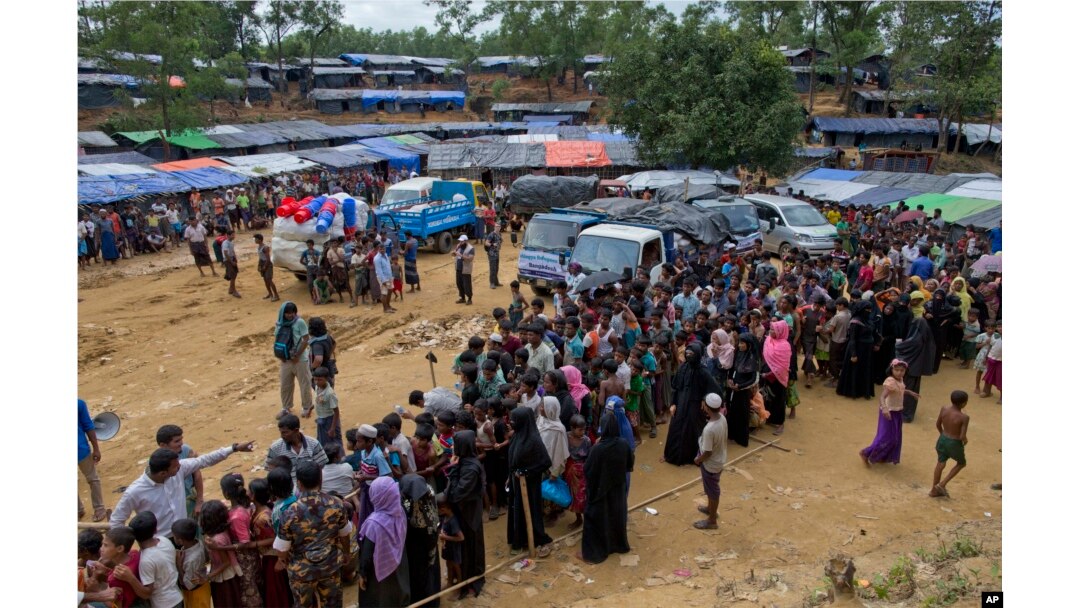 Newly arrived Rohingya refugees stand in a line to receive food rations in Kutupalong, Bangladesh, Sept. 30, 2017.