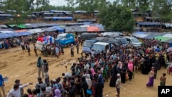 FILE - Newly arrived Rohingya refugees stand in a line to receive food rations in Kutupalong, Bangladesh, Sept. 30, 2017. 