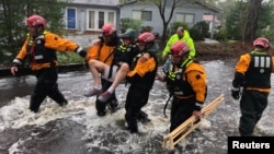 Search and Rescue workers from New York rescue a man from flooding caused by Hurricane Florence in River Bend, North Carolina, U.S. in this Sept. 14, 2018 handout photo. 