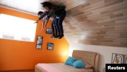 People pose for a photo inside the upside down house, in Guatavita, Colombia, January 23, 2022. (REUTERS/Luisa Gonzalez)