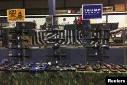 Guns are on display inside the Ohio Gun, Knife & Military Show at the Summit County Fairgrounds in Tallmadge, Ohio, Oct. 30, 2016.