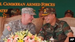 Lt. Gen. Hun Manet, right, son of Cambodian Prime Minister Hun Sen and deputy commander of the Royal Cambodian Army and Commander of the National Counter Terror Special Force, talks with an U.S. Army Pacific Representative Brg. Gen. John Goodale, left, as they preside over a U.S.-backed peacekeeping exercise dubbed "Angkor Sentinel 2014" at the Cambodian tank command headquarters in Kampong Speu province, file photo. 