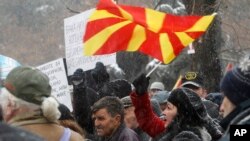 Opponents to the change of the country's constitutional name protest outside the parliament building prior to a session of the Macedonian Parliament in the capital Skopje, Jan. 9, 2019. 