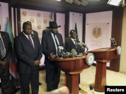South Sudan President Salva Kiir (C), flanked by former rebel leader Riek Machar (L) and other government officials, addresses a news conference at the Presidential State House in Juba, South Sudan, July 8, 2016.