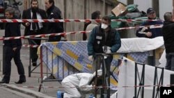 Police gather at the site of a shooting in Toulouse, southwestern France, Monday, March 19, 2012. 