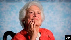 FILE - Former first lady Barbara Bush listens to her son, President George W. Bush, as he speaks on Social Security reform in Orlando, Florida, March 18, 2005.