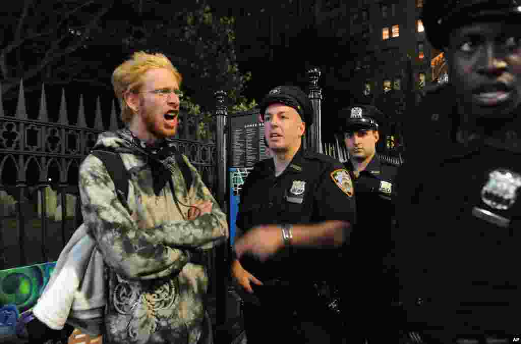 A person associated with the Occupy movement is arrested in New York in front of Trinity church, September 15, 2012. 