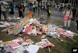 Placards showing anti-Trump messages lie on the ground, in central London, near the end of a protest against the state visit of President Donald Trump, June 4, 2019.