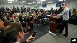 New England Patriots quarterback Tom Brady faces members of the media at a news conference in Foxborough, Mass., Thursday, Jan. 22, 2015. Brady said Thursday that he did not know how New England ended up using underinflated balls in its win Sunday against the Indianapolis Colts in the AFC Championship game. (AP Photo/Elise Amendola)