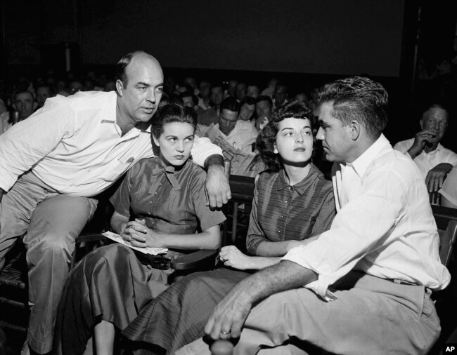 FILE - In this Sept. 23, 1955, file photo, J.W. Milam, left, his wife, second left, Roy Bryant, far right, and his wife, Carolyn Bryant, sit together in a courtroom in Sumner, Miss. Bryant and his half-brother Milam were charged with murder but acquitted.
