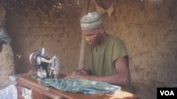 Electricity has enabled people in some areas of northern Nigeria to open businesses, such as this man’s tailoring enterprise (SELF)