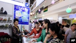 FILE - Attendees at the 20th Pyongyang Spring International Trade Fair in Pyongyang, May 22, 2017.