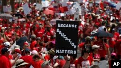Thousands march to the Arizona Capitol for higher teacher pay and school funding in Phoenix, April 26, 2018.