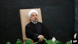 Iranian President Hassan Rouhani waits to address the 68th United Nations General Assembly, UN headquarters, New York, Sept. 24, 2013.