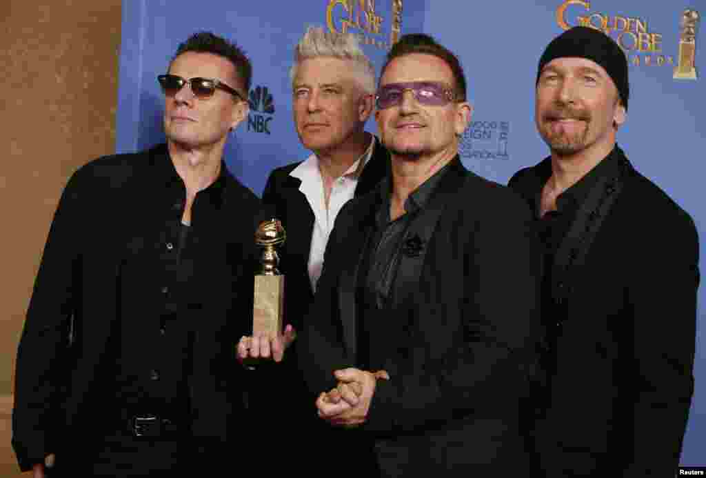 Adam Clayton, Bono, Larry Mullen, Jr. and The Edge from the band U2 pose backstage with their award for Best Original Song for&quot; Ordinary Love&quot; from the film &quot;Mandela: Long Walk to Freedom&quot; Jan. 12, 2014.