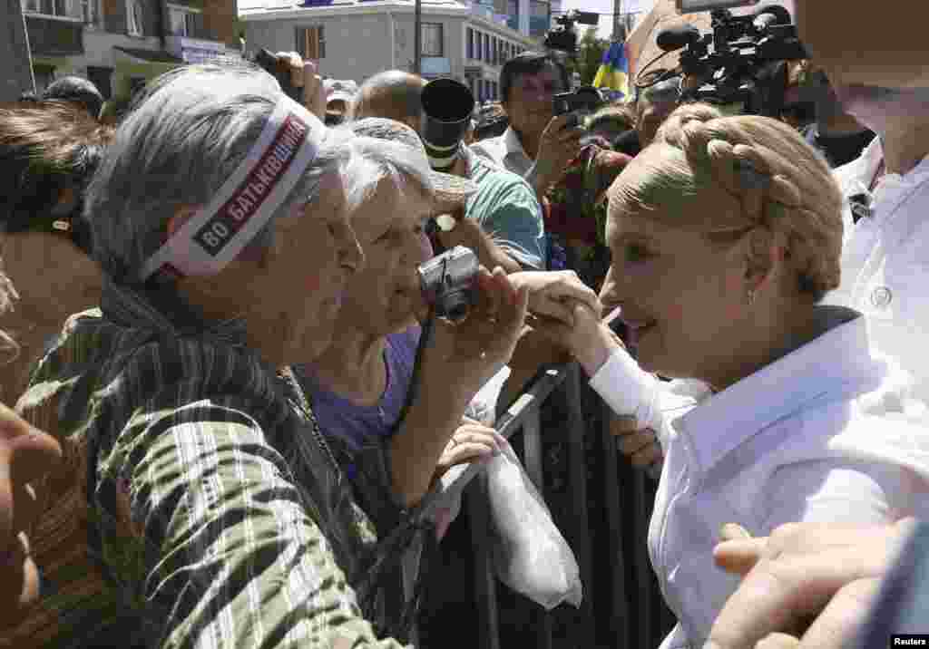 Former Ukrainian prime minister and current presidential candidate Yulia Tymoshenko (right) meets supporters during her election campaign, Konotop, May 21, 2014.