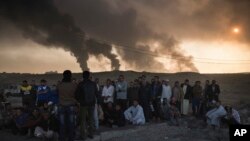 Abagabo bafashwe n'abasirikare ba reta ya Iraki bariko bagirwako amatohozwa ahitwa Qayara, mu Bumanuko bwa Mosul.