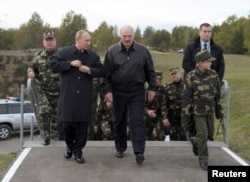 Russian President Vladimir Putin (front left) speaks with his Belarusian counterpart Alyaksandr Lukashenka during the closing stages of the Zapad war games in 2013.