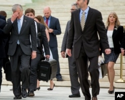 Former Virginia Gov. Bob McDonnell, left, with his wife Maureen McDonnell, right, leave the Supreme Court last year.