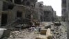 A view shows debris along a street of damaged buildings by what activists said was shelling by forces loyal to Syria's President Bashar al-Assad in Homs, Apr. 8, 2013. 
