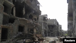 A view shows debris along a street of damaged buildings by what activists said was shelling by forces loyal to Syria's President Bashar al-Assad in Homs, Apr. 8, 2013. 