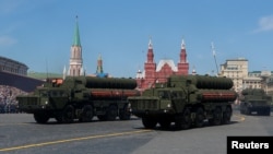 FILE - Russian servicemen drive S-400 missile air defense systems during the Victory Day parade, marking the 73rd anniversary of the victory over Nazi Germany in World War II, at Red Square in Moscow, Russia, May 9, 2018. 