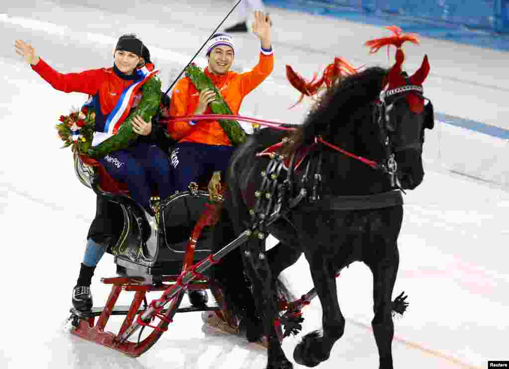 Kai Verbij (r) of the Netherlands and Karolina Erbanova of the Czech Republic, gold medal winners of &nbsp;ISU European Speed Skating Championships, ride on a horse carriage in Heerenveen, the Netherlands.