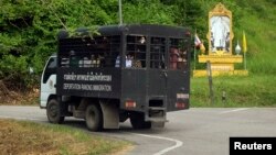 Thai immigration police van carries a group of Rohingya Muslims to a port outside Ranong, Oct. 30, 2013.