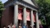  People are led on a tour on the campus of Harvard University in Cambridge, Mass