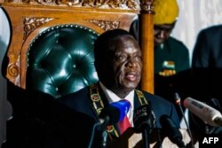 FILE - Zimbabwean President Emmerson Mnangagwa delivers his state of the nation address at a joint sitting of the parliament and the senate in Harare on December 20, 2017.