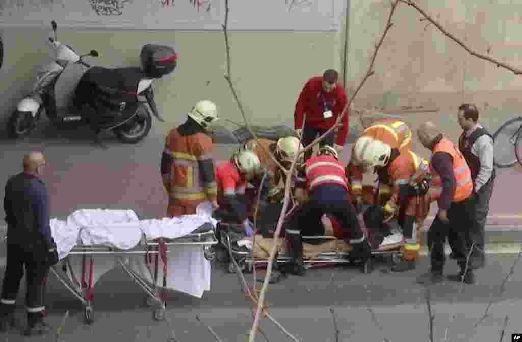 In this image made from video, emergency rescue workers stretcher an unidentified person at the site of an explosion at a metro station in Brussels, March 22, 2016.