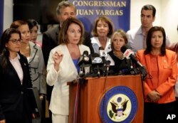 House Minority Leader Nancy Pelosi, D-Calif., at podium, speaks in front of members of the Congressional Hispanic Caucus during a visit to the border Monday, June 18, 2018, in San Diego, California.