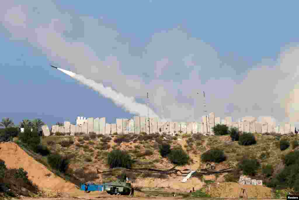 A rocket is launched by Palestinian militant groups into the Mediterranean Sea off the Gaza Strip at the start of their first-ever joint exercise, in Gaza City.