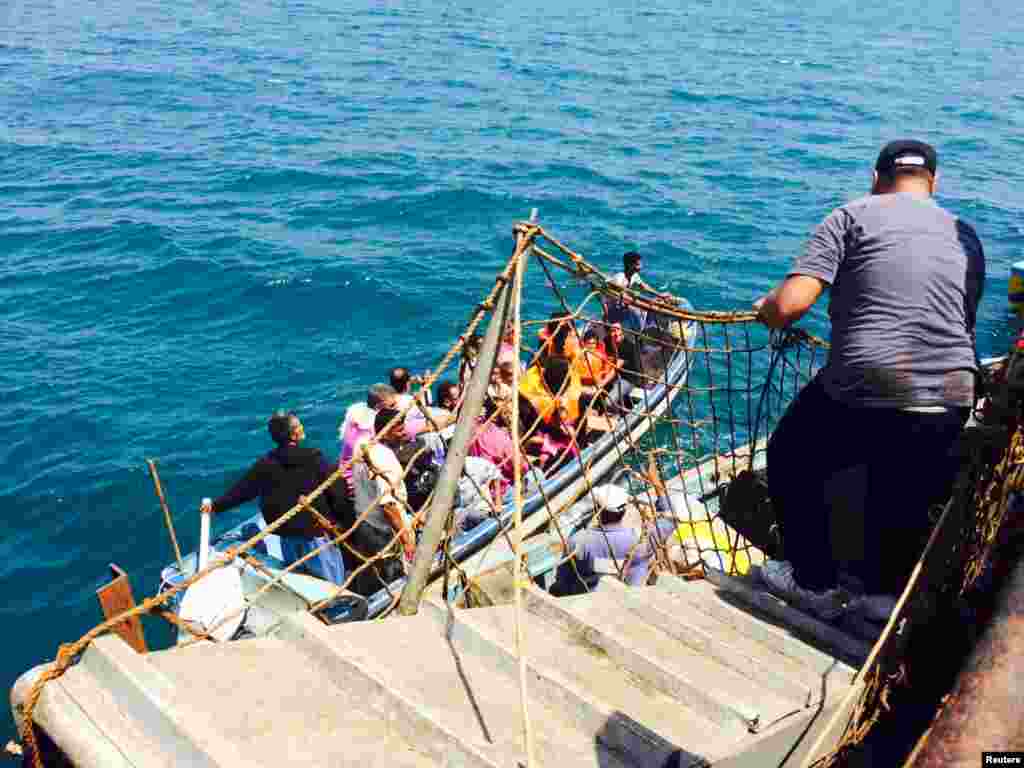 Passengers board the Yemeni-owned Sea Princess II oil tanker, chartered to carry people of various nationalities fleeing Aden, as Houthi fighters advanced, April 1, 2015.