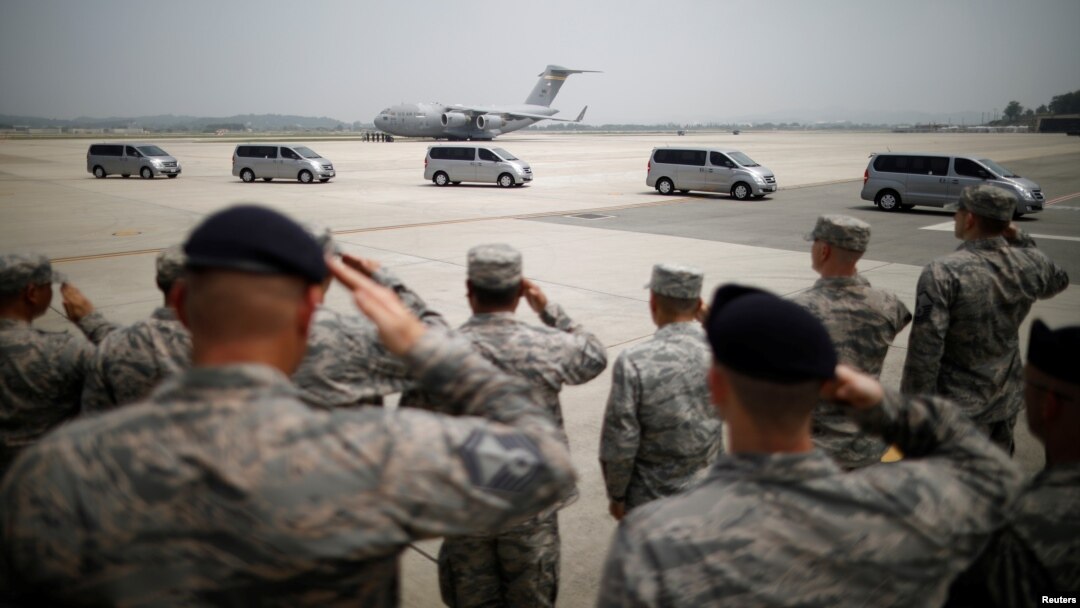 U.S. soldiers salute vehicles transporting the remains of 55 U.S. soldiers who were killed in the Korean War at Osan Air Base in Pyeongtaek, South Korea, July 27, 2018.