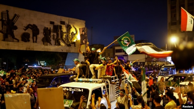 Iraqi supporters of Sadr's movement celebrate preliminary results of parliamentary elections in Baghdad, Iraq, October 11, 2021.