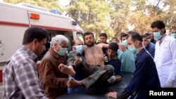 Residents and medics transport a Syrian Army soldier, wounded in what they said was a chemical weapon attack near Aleppo, to a hospital, March 19, 2013.