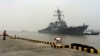 FILE - Chinese Navy personnel stand guard as guided missile destroyer USS Stethem arrives at the Shanghai International Passenger Quay for a scheduled port visit in Shanghai, China, Nov. 16, 2015. 